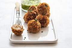 Homemade meatballs with thyme and green sauce on a white plate on white background. royalty free stock image Homemade meatballs with thyme and green sauce on a white plate on white background. royalty free stock image
