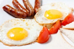 Fried eggs and fried sausage stock photo Fried eggs and fried sausage stock photo