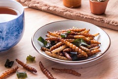 Fried insects - Bamboo worm insect crispy with pandan after fried and add a light coating of sauce and garnish Thai pepper powder royalty free stock photos Fried insects - Bamboo worm insect crispy with pandan after fried and add a light coating of sauce and garnish Thai pepper powder royalty free stock photos