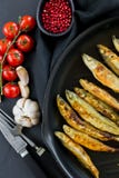 Fried mackerel in a pan. Black background, top view, space for text stock photos Fried mackerel in a pan. Black background, top view, space for text stock photos