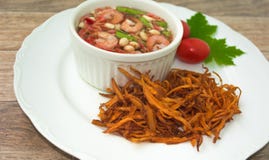 Fried papaya salad. On wood background stock photo Fried papaya salad. On wood background stock photo