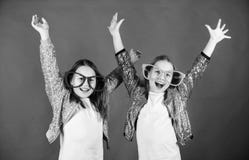 Friendly relations siblings. Sincere cheerful kids share happiness and love. Girls funny big eyeglasses cheerful smile stock photography Friendly relations siblings. Sincere cheerful kids share happiness and love. Girls funny big eyeglasses cheerful smile stock photography