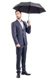 Surprised businessman holding an umbrella. royalty free stock photography Surprised businessman holding an umbrella. royalty free stock photography