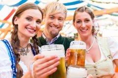 Friends with beer glasses at Bavarian beer tent royalty free stock photos Friends with beer glasses at Bavarian beer tent royalty free stock photos