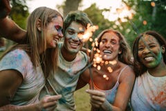 Group of friends burning fire sparkles while playing holi royalty free stock photography Group of friends burning fire sparkles while playing holi royalty free stock photography