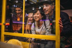 Friends playing toy grabbing game at amusement park royalty free stock photo Friends playing toy grabbing game at amusement park royalty free stock photo