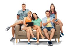Friends with tablet pc and smartphones sit on sofa Stock Photography Friends with tablet pc and smartphones sit on sofa Stock Photography