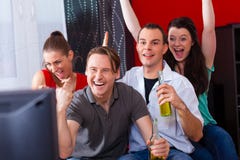 Friends Watching Exciting Game At TV Stock Images Friends Watching Exciting Game At TV Stock Images