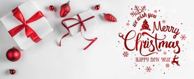 Frohe Weihnachten typografisch auf weißem Hintergrund mit Geschenkboxen und roter Dekoration lizenzfreies stockfoto Frohe Weihnachten typografisch auf weißem Hintergrund mit Geschenkboxen und roter Dekoration lizenzfreies stockfoto