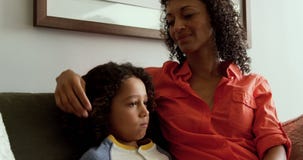 Front view of African american mother consoling her son in the lobby at hospital 4k stock video footage Front view of African american mother consoling her son in the lobby at hospital 4k stock video footage