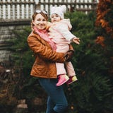 Attractive mom playing and holding by hands her daughter. royalty free stock photo Attractive mom playing and holding by hands her daughter. royalty free stock photo