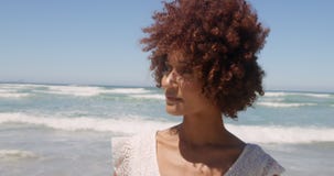 Front view of young African american woman walking on beach in the sunshine 4k stock video footage Front view of young African american woman walking on beach in the sunshine 4k stock video footage
