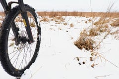 The front wheel of mountain bike in the first snow. stock image The front wheel of mountain bike in the first snow. stock image