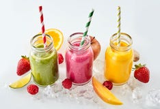 Fruit pieces and smoothies in a row royalty free stock photography Fruit pieces and smoothies in a row royalty free stock photography