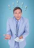 Frustrated business man with money against blue background and exclamation points Stock Photography Frustrated business man with money against blue background and exclamation points Stock Photography