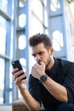 Frustrerad entreprenör som har problemet som läser via mobil negativ återkoppling om hans projekt arkivfoton Frustrerad entreprenör som har problemet som läser via mobil negativ återkoppling om hans projekt arkivfoton