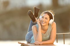 Happy girl listens to music looking at side royalty free stock photo Happy girl listens to music looking at side royalty free stock photo
