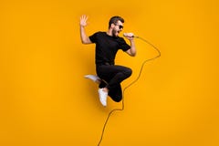 Full body profile photo of crazy hipster guy jumping high holding microphone music lover singing favorite song wear sun