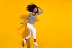 Full length body size photo woman jumping high looking far on blank space isolated bright yellow color background. 