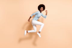 Full length body size side profile photo of funny dark skinned curly girl jumping high running fast laughing loudly