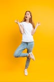 Full length, cheerful girl is meditating in a good mood, on a yellow background royalty free stock images Full length, cheerful girl is meditating in a good mood, on a yellow background royalty free stock images