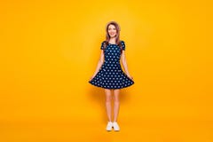 Full-length, fullbody portrait of nice, cheerful, positive, childish, comic, funny, cute girl, holding bottom of polka-dot dress stock photography Full-length, fullbody portrait of nice, cheerful, positive, childish, comic, funny, cute girl, holding bottom of polka-dot dress stock photography