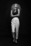Full-length monochrome portrait of young woman posing over black background. Fashion studio shot. Royalty Free Stock Photos Full-length monochrome portrait of young woman posing over black background. Fashion studio shot. Royalty Free Stock Photos