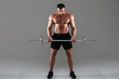 Full length portrait of a confident strong shirtless male bodybuilder stock photo Full length portrait of a confident strong shirtless male bodybuilder stock photo