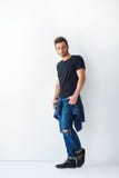 Full length portrait of handsome stylish man leaning at white wa Royalty Free Stock Photo Full length portrait of handsome stylish man leaning at white wa Royalty Free Stock Photo