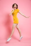 Full length portrait of happy exited woman in elegant yellow dre Royalty Free Stock Image Full length portrait of happy exited woman in elegant yellow dre Royalty Free Stock Image