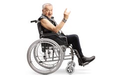 Mature man in a wheelchair making a rock and roll hand sign and looking at the camera stock images Mature man in a wheelchair making a rock and roll hand sign and looking at the camera stock images