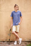 Skater dude. Full-length shot of a teenage boy standing with his skateboard.