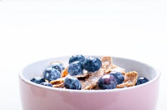 Full Muesli Bowl On A White Table With Blueberry And Milk Splash. Healthy Breakfast Cereals With Milk, Seed, Fruit. Oat Flakes Stock Photography Full Muesli Bowl On A White Table With Blueberry And Milk Splash. Healthy Breakfast Cereals With Milk, Seed, Fruit. Oat Flakes Stock Photography