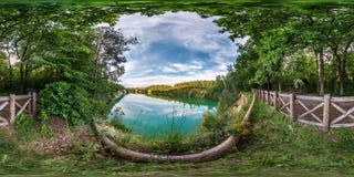 Full seamless spherical hdri panorama 360 degrees angle view on limestone coast of huge green lake or river near forest in summer