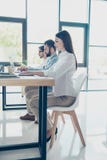 Full size low angle shot of three workers sitting in the office. stock photos Full size low angle shot of three workers sitting in the office. stock photos