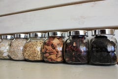 Fulled with tea, seeds and dried fruits glass banks on the wooden white background royalty free stock image Fulled with tea, seeds and dried fruits glass banks on the wooden white background royalty free stock image