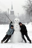 Fun and happiness. Boy and girl with a snowman Fun and happiness. Boy and girl with a snowman