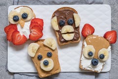 Funny animal faces toasts with banana, strawberry and blueberry. Funny animal faces toasts with spreads, banana, strawberry and blueberry stock photo Funny animal faces toasts with banana, strawberry and blueberry. Funny animal faces toasts with spreads, banana, strawberry and blueberry stock photo