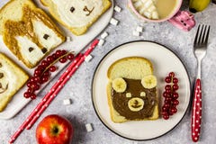 Funny animal sandwich for kids shaped cute bear, panda, fox, rabbit. With peanut butter, honey, chocolate paste and banana. Top vew stock images Funny animal sandwich for kids shaped cute bear, panda, fox, rabbit. With peanut butter, honey, chocolate paste and banana. Top vew stock images