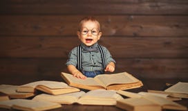 Funny baby with books in glasses stock images Funny baby with books in glasses stock images