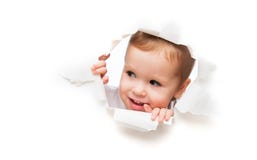 Funny child baby girl peeping through hole in an empty white p royalty free stock photos Funny child baby girl peeping through hole in an empty white p royalty free stock photos