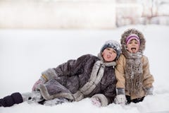 Funny children playing and laughing on snowy winter park stock photography Funny children playing and laughing on snowy winter park stock photography