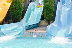 Funny childs having fun colorful water slide ride at Water Park in International Drive area. stock photos Funny childs having fun colorful water slide ride at Water Park in International Drive area. stock photos