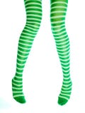 Funny female legs in green striped stockings. Irish girl, isolated on white royalty free stock images Funny female legs in green striped stockings. Irish girl, isolated on white royalty free stock images