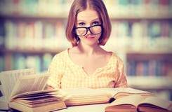 Funny girl student with glasses reading books royalty free stock photography Funny girl student with glasses reading books royalty free stock photography