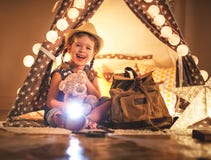 Funny child girl tourist with flashlight and world map and backp Stock Photos Funny child girl tourist with flashlight and world map and backp Stock Photos