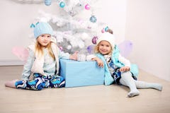 Funny Little Girls Posing Beside A Decorated Christmas Tree Stock Image Funny Little Girls Posing Beside A Decorated Christmas Tree Stock Image