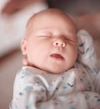 Funny newborn baby sleeps in the arms of his mother stock images Funny newborn baby sleeps in the arms of his mother stock images