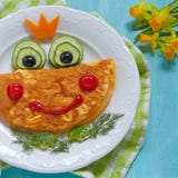 Funny smiling frog princess omelette stock photo Funny smiling frog princess omelette stock photo