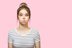 Funny woman blowing cheeks. pink background royalty free stock images Funny woman blowing cheeks. pink background royalty free stock images